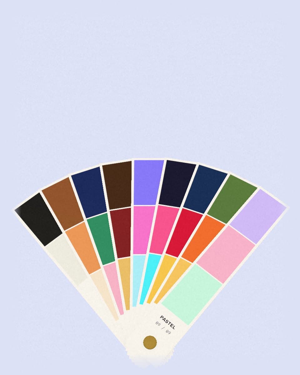 A fan deck of vibe swatch cards spread open on a brass pivot.